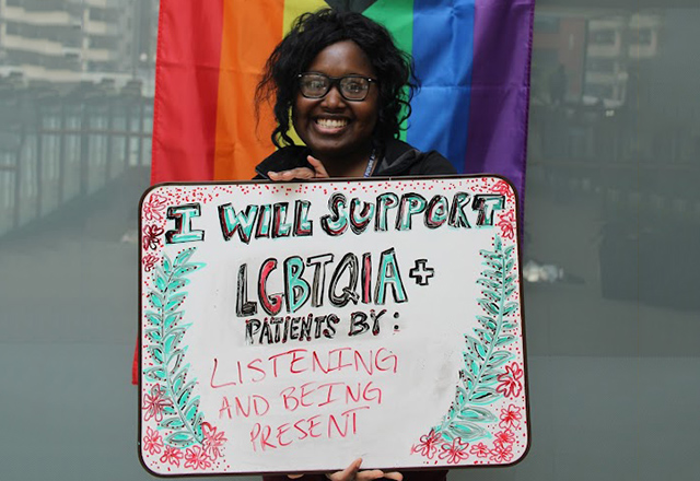 Student sharing poster with support of LGBTQ